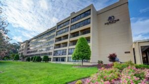 A view of the Doubletree Hilton from a distance, with a flower outside.